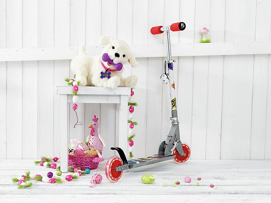 A Childs Scooter Next To A Stool With A Stuffed Animal And Easter Decorations Photograph by Biglife