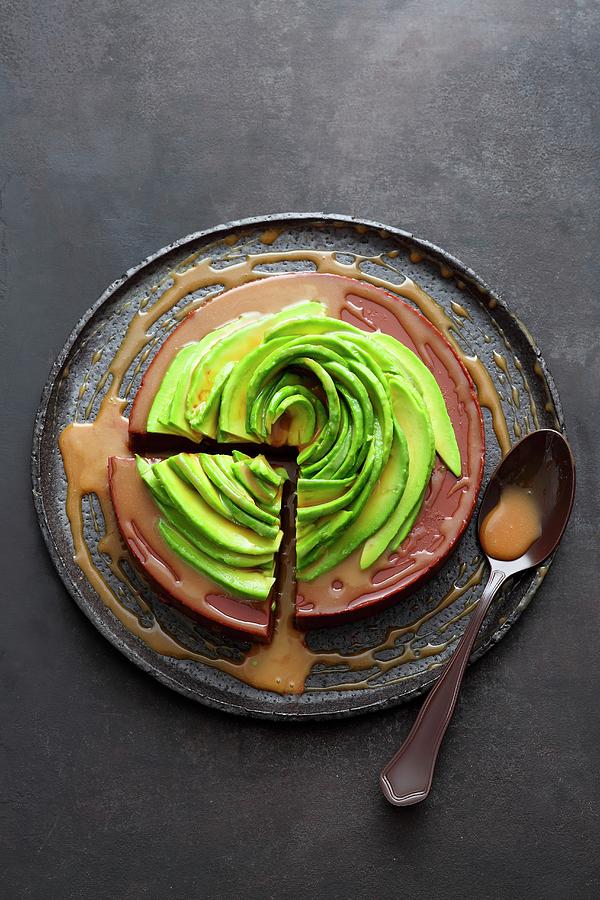 A Chocolate And Passion Fruit Cake Topped With An Avocado Rose And Caramel And Rum Syrup Photograph by Jalag / Mathias Neubauer