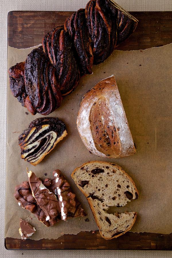 A Chocolate Babka Swirl Cake, Chocolate Bread And A Chocolate Bar With Nuts On A Rustic Background Photograph by Andre Baranowski