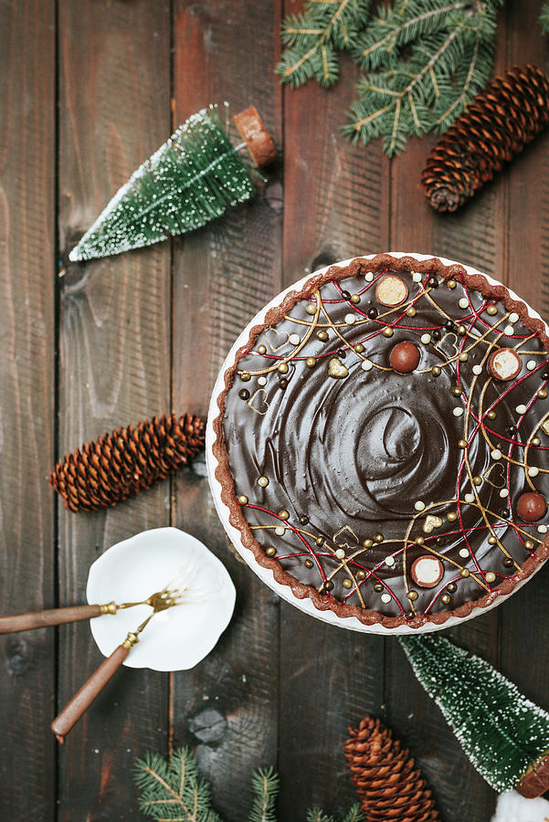 A Chocolate Cake Surrounded With Christmas Decorations Photograph by Visnja Sesum