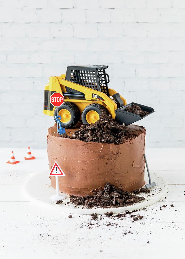 A Chocolate Cake Topped With A Digger And Building Site Decorations Photograph by Emma Friedrichs