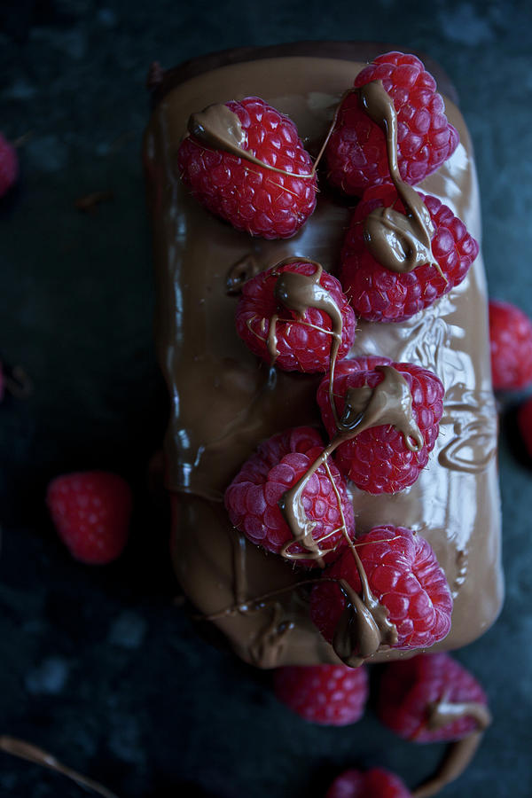 A Chocolate Cake Topped With Milk Chocolate And Raspberries Photograph by Ryla Campbell