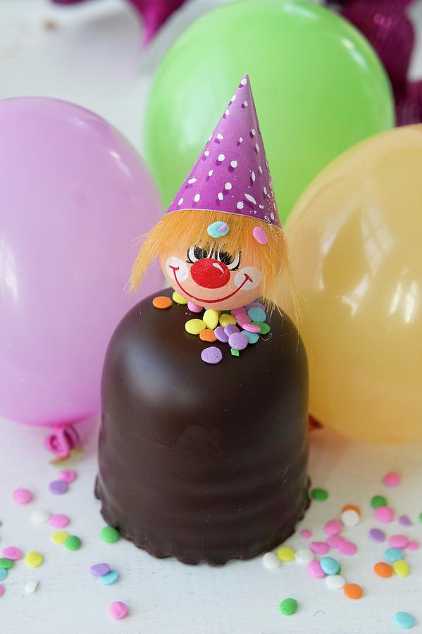 A Chocolate Candy With A Clown Face, Balloons And Sugar Confetti Photograph by Martina Schindler