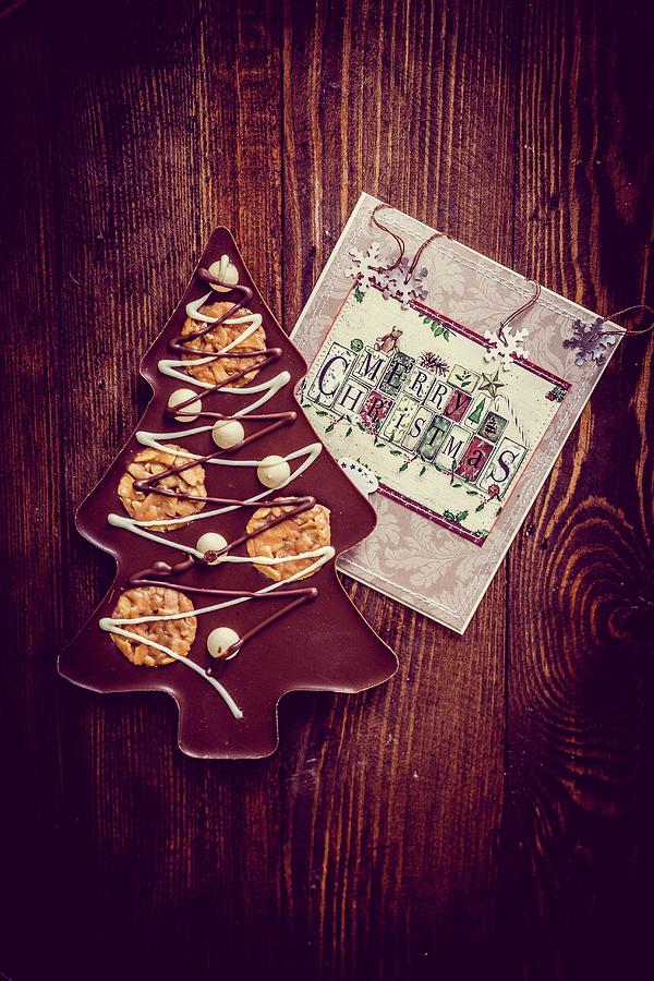Candy Photograph - A Chocolate Christmas Tree On A Wooden Surface by Alena Haurylik