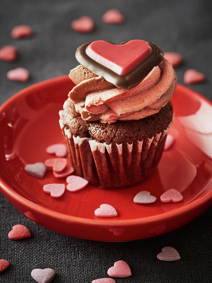 A Chocolate Cupcake Topped With Buttercream And Decorated With A Chocolate Heart For Valentines Day Photograph by Alexander Van Berge