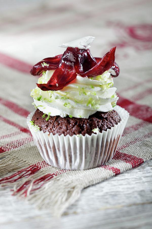 A Chocolate Cupcake Topped With Lime Cream Photograph by Niklas Thiemann