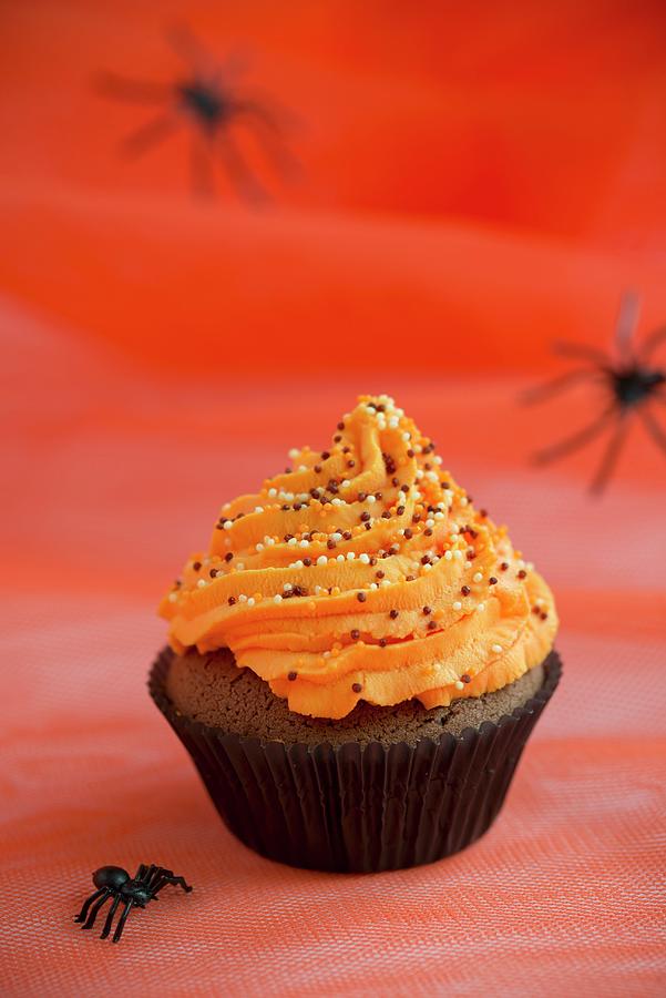 A Chocolate Cupcake Topped With Orange Buttercream For Halloween Photograph by Ewa Rejmer