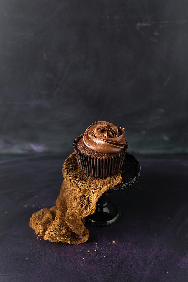 A Chocolate Cupcake With Chocolate Cream Icing Photograph by Mandy Reschke