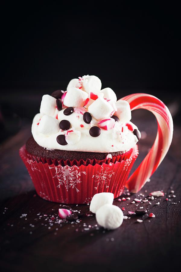 A Chocolate Cupcake With Marshmallows And A Candy Cane Photograph by Eising Studio