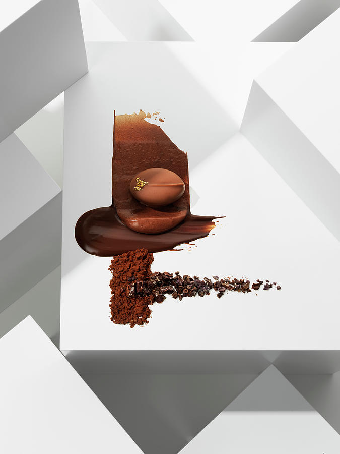 A Chocolate Praline On Various Chocolate Textures Photograph by Armin Zogbaum