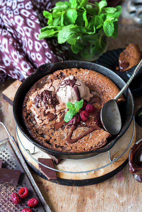 A Chocolate Skillet Pancake With Vanilla Ice Cream And Raspberries Photograph by Irina Meliukh