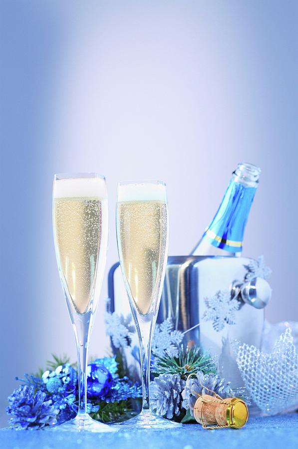 A Christmas Arrangement Of Champagne With Glasses And A Cooler Photograph by Perry Jackson