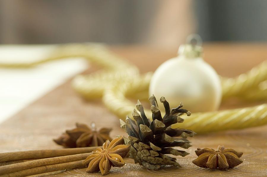 A Christmas Arrangement With Star Anise, Cinnamon Sticks And Pine Cones Photograph by Achim Sass