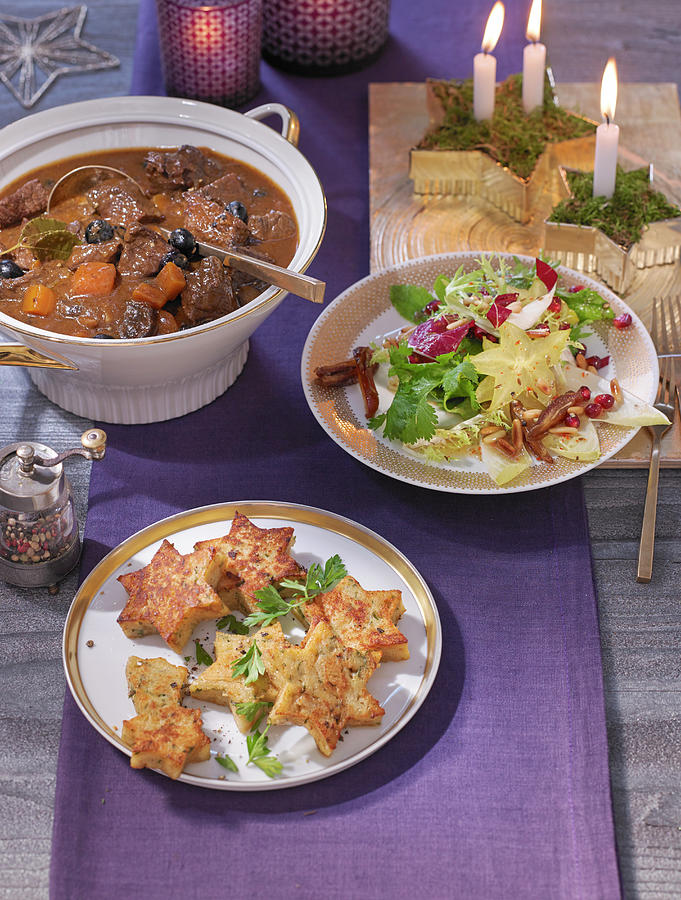 A Christmas Buffet With Wild Goulash, Blueberry And Chicory Salad And Bread Dumpling Stars Photograph by Jan-peter Westermann