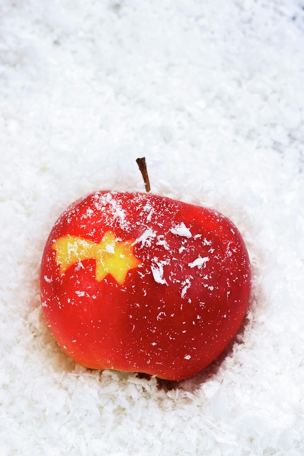 A Christmas Star Carved Into A Red Apple Photograph by Petr Gross