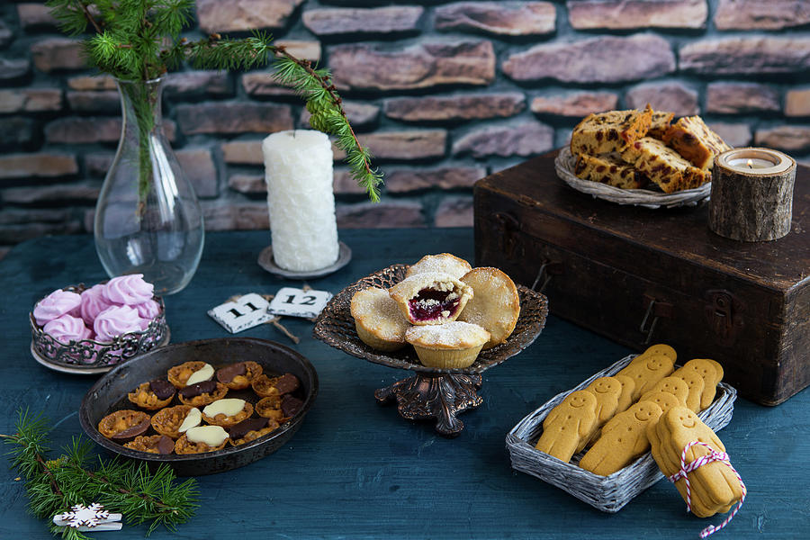 A Christmas Table Laid With Various Christmas Cakes And Biscuits Photograph by Aniko Takacs