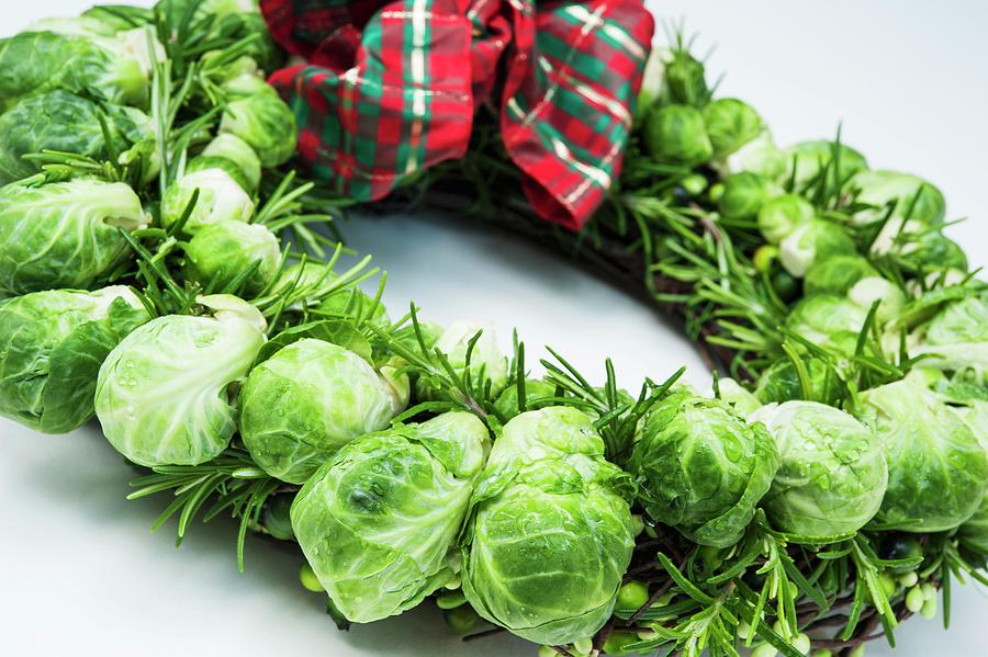 A Christmas Wreath Made With Brussels Sprouts And Rosemary With A Checked Ribbon Photograph by Linda Burgess
