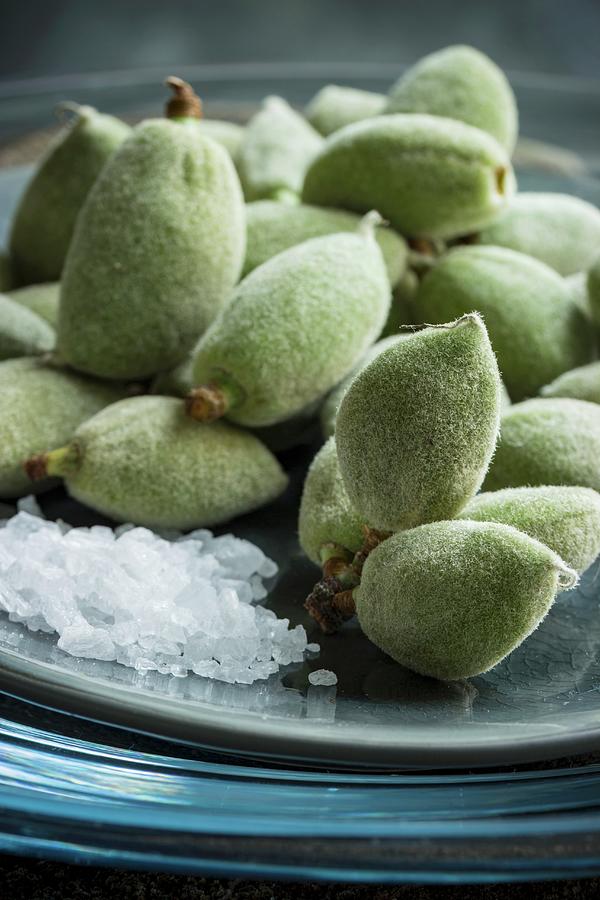 A Close-up Of Green Almonds With Sea Salt On A Plate Photograph by Charlotte Von Elm