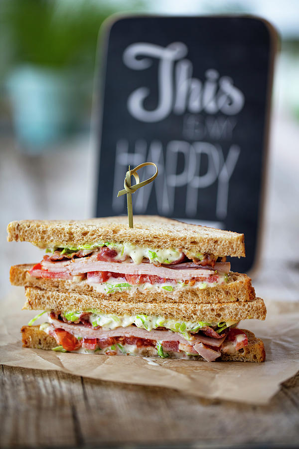 A Club Sandwich With Turkey Breast And Bacon Photograph by Jan Wischnewski