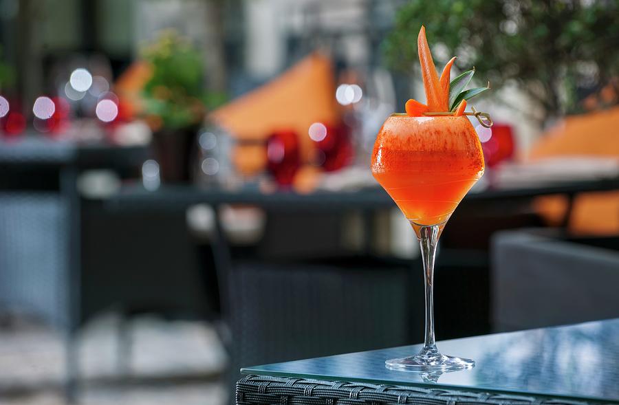 A Cocktail Garnish With Melon Carrots On A Patio Table buddha-bar Hotel, Paris Photograph by Christophe Madamour