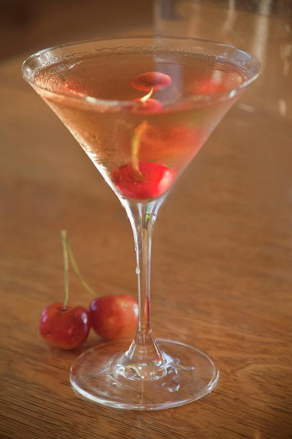A Cocktail Made With Vodka And Cherries In A Martini Glass Photograph by William Boch