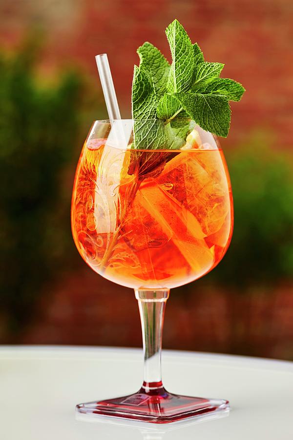 A Cocktail With Aperol And Fresh Mint Photograph by Herbert Lehmann