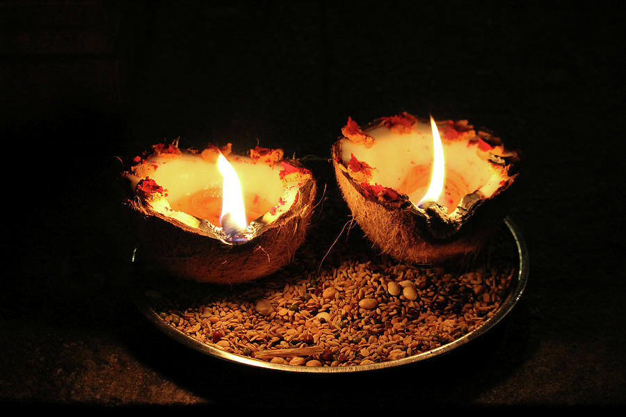 A Coconut Used As an Oillamp and Lit Photograph by Indunil Usgoda ...