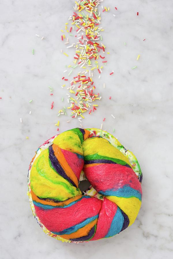 A Colourful Bagel With Cream Cheese And Sprinkles Photograph by Etorres
