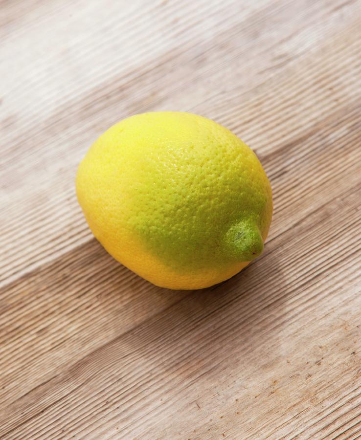 A Combination Of A Lemon And A Lime On An Old Wooden Surface Photograph by William Boch