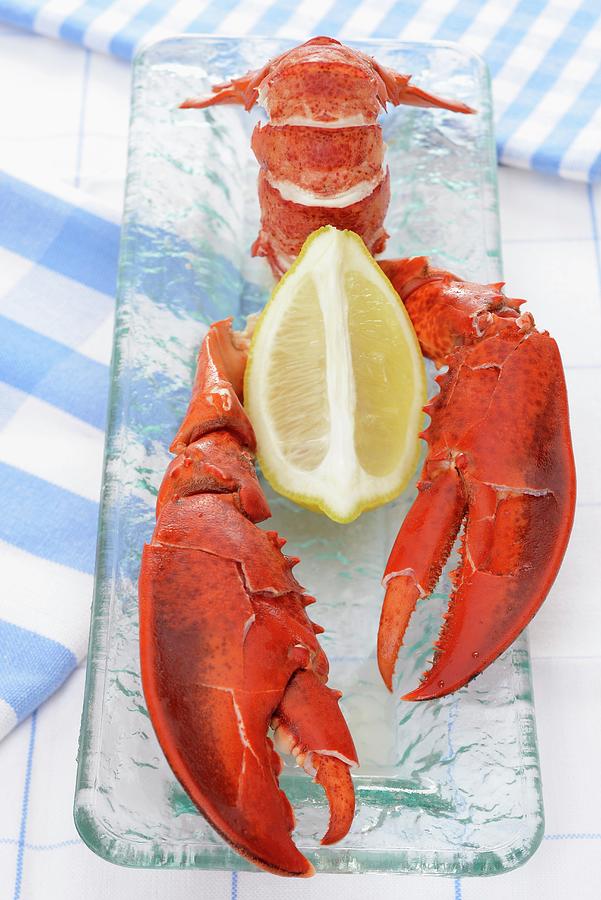 A Cooked Lobster With A Lemon Photograph by Caste, Alain