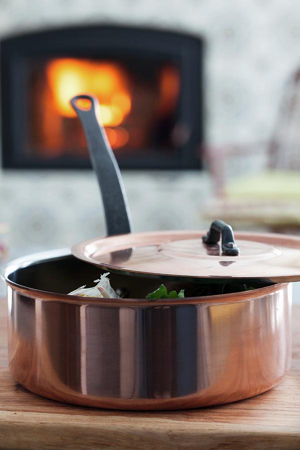 A Copper Pan In Front Of A Fireplace Photograph by Yelena Strokin