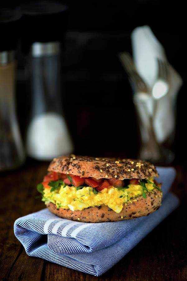 A Corn Bagel With Egg And Cress With Mayonnaise, Rocket And Tomato Photograph by Jamie Watson