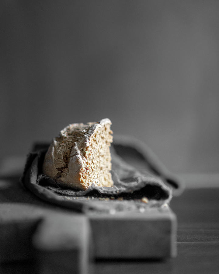 A Corner Of Freshly Baked Bread On A Linen Cloth Against A Gray Background Photograph by Corina Bouweriks Fotografie