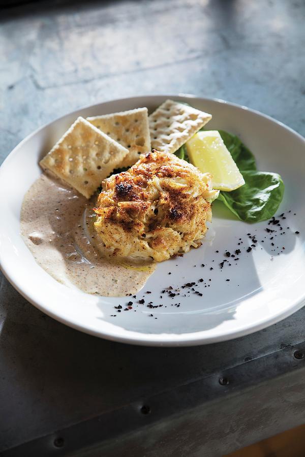 A Crab Cake With Remoulade Sauce And Salted Crackers Photograph by Cindy Haigwood