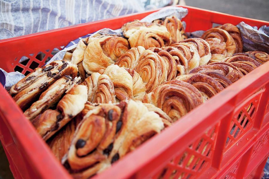 Holiday Photograph - A Crate Of Danish Pastries At A Bakery by Claudia Timmann
