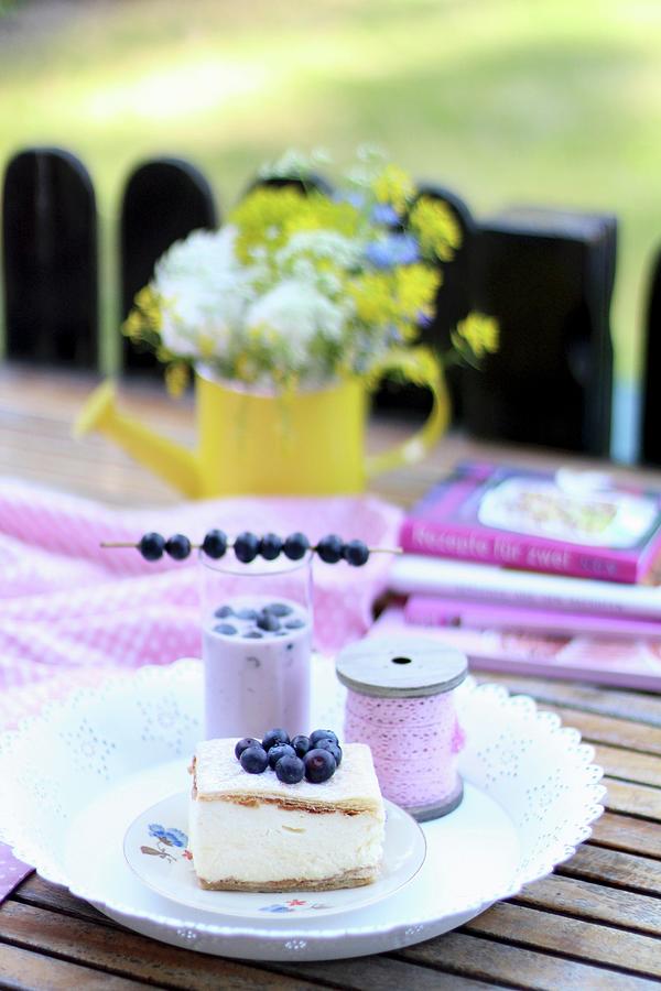 A Cream Slice And A Milkshake With Blueberries On A Summer Table Outside Photograph by Sylvia E.k Photography