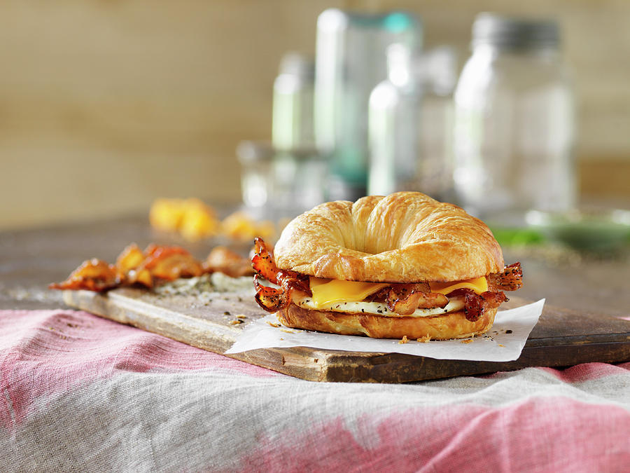 A Croissant Sandwich With Egg, Bacon And Cheese Photograph by Jim Scherer