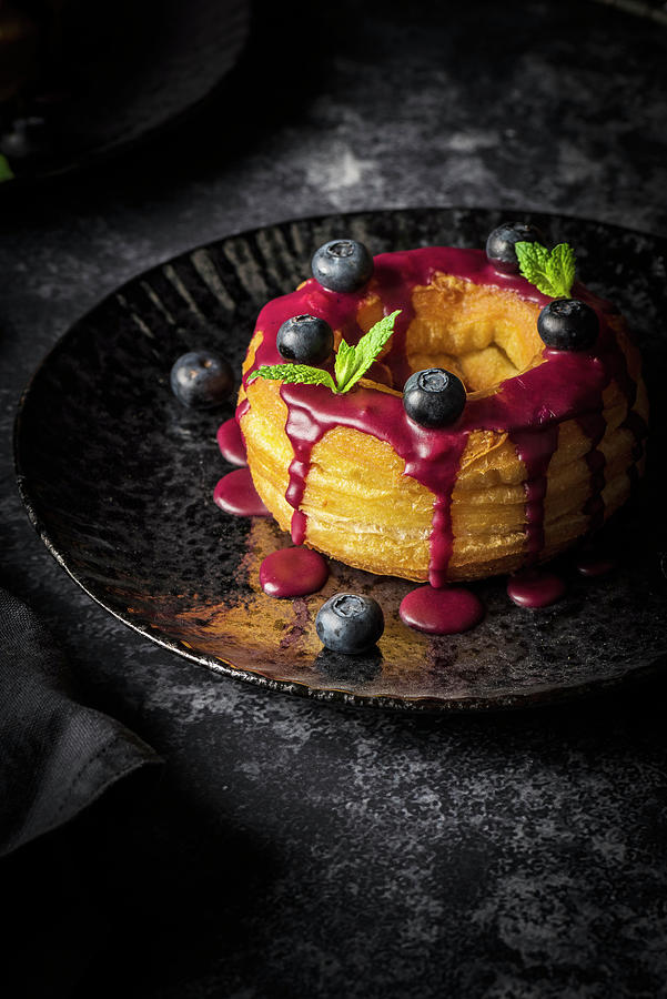 A Cronut Filled With Blueberry Cream And Covered With Frosting Photograph by Christian Kutschka