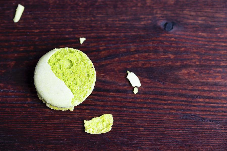 A Crumbled Pistachio Macaroon On A Wooden Surface Photograph by Mandy Reschke