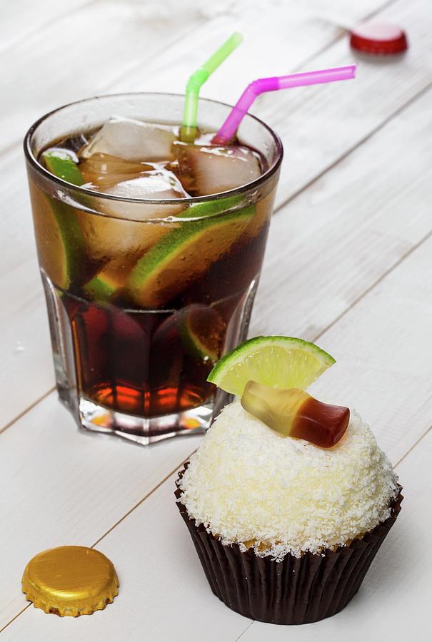 A Cuba Libre Cupcake And The Cocktail Of The Same Name Photograph by Foodandvicious
