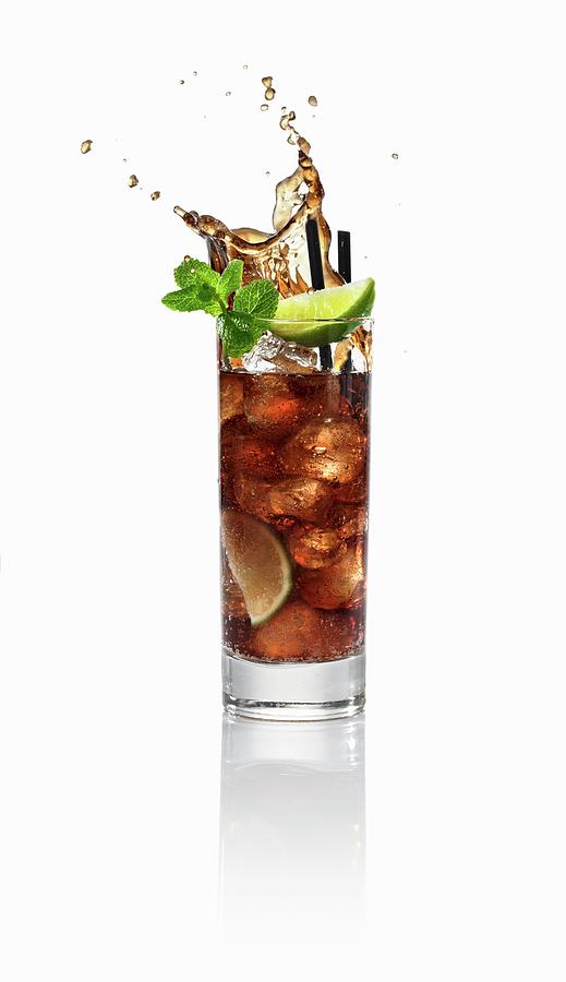 A Cuba Libre Splashing Out Of The Glass Photograph by Krger & Gross