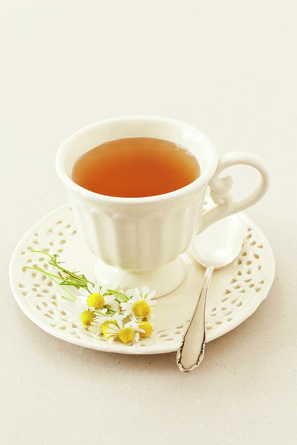 A Cup Of Camomile Tea And Fresh Camomile Flowers Photograph by Rua Castilho