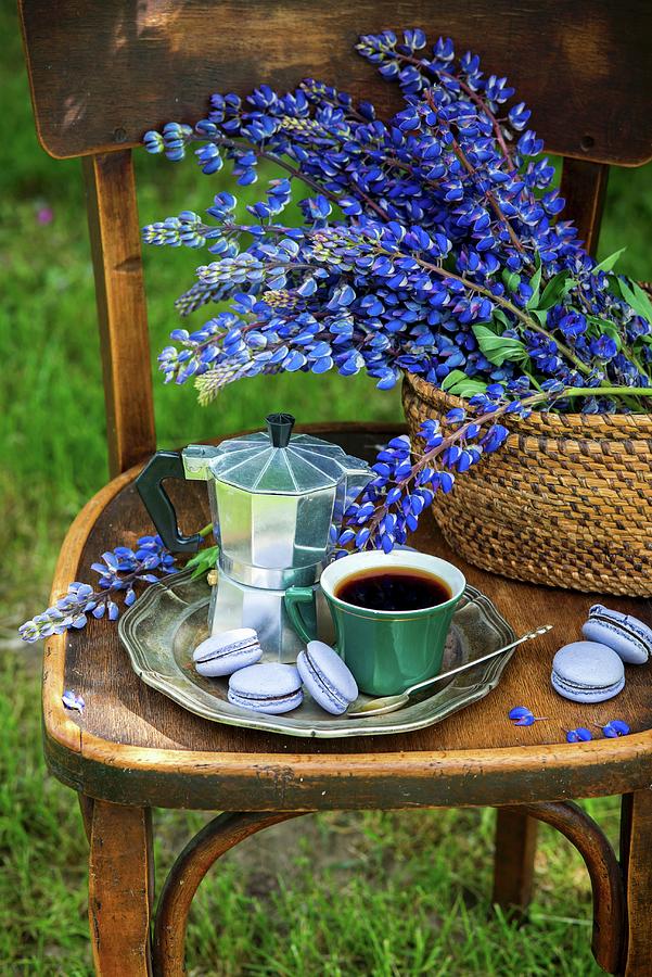 A Cup Of Coffee, An Espresso Pot, And Macarons On A Silver Tray, With Lupines In A Basket outdoor Garden Photograph by Irina Meliukh
