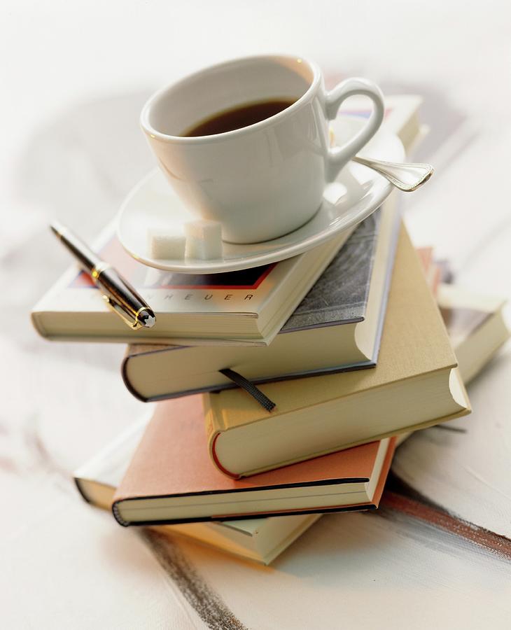 A Cup Of Coffee On Top Of A Stack Of Books Photograph by Michael Wissing