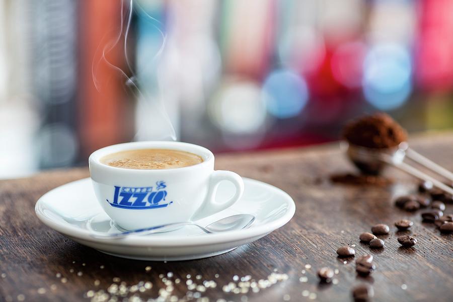 A Cup Of Espresso, Sugar, Coffee Beans And Coffee Powder On A Wooden Table Photograph by Jan Prerovsky