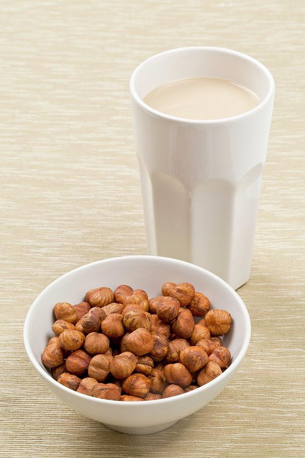 A Cup Of Hazelnut Milk And A Bowl Of Hazelnuts Photograph by Shawn Hempel