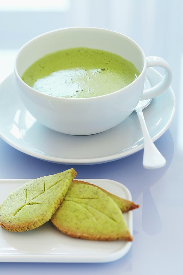 A Cup Of Matcha Tea With Leaf-shaped Matcha Biscuits Photograph by Franziska Taube