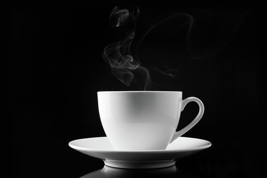 A Cup Of Smoking Hot Coffee On A Black Photograph by V2images