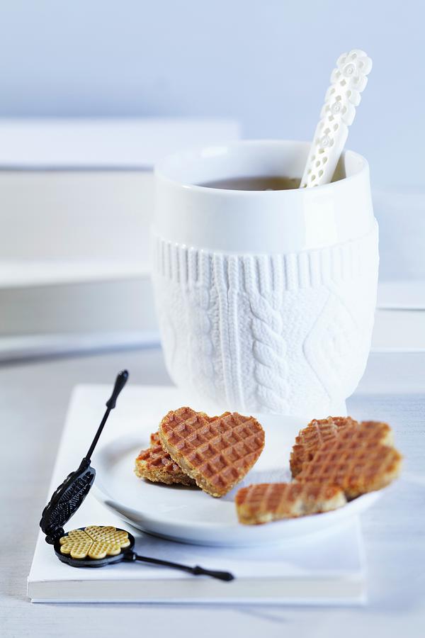A Cup Of Tea, Heart-shaped Waffles And A Mini Waffle Iron Photograph by Taube, Franziska