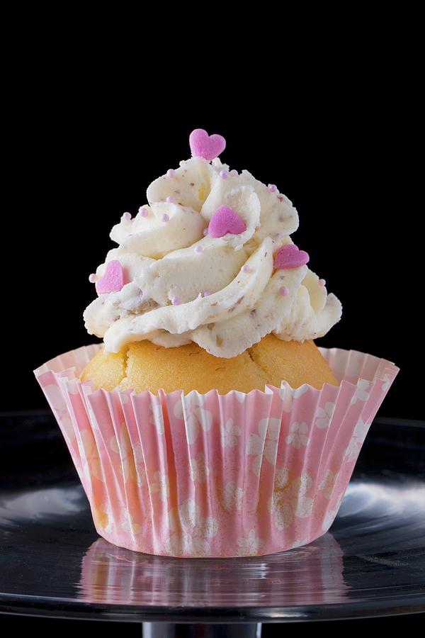 A Cupcake Decorated With Buttercream And Pink Hearts Photograph by Lydie Besancon